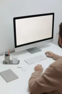 Free Crop man working on computer in workplace Stock Photo